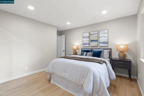 a bedroom with a bed and a lamp