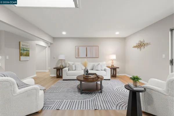 a living room with furniture and a rug