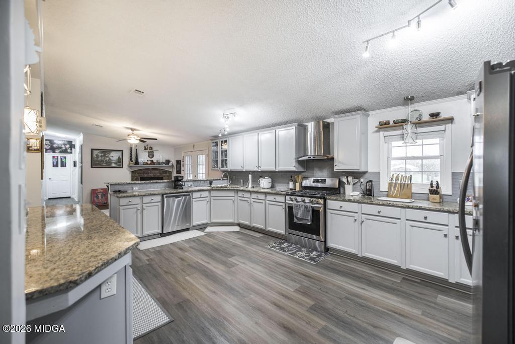 319 Pope Road Roberta, GA 31078 - Photo 10 of 42 a kitchen with granite countertop stainless steel appliances and wooden cabinets