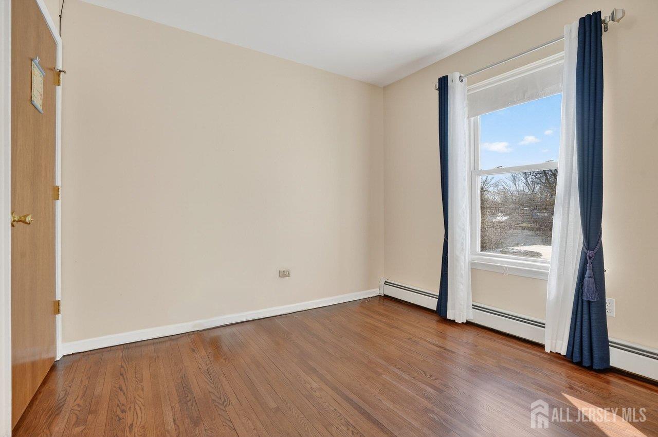 1 Wakefield Drive Edison, NJ 08820 - Photo 18 of 29 an empty room with wooden floor and windows