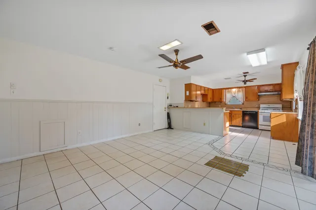 a view of a kitchen with furniture and appliances
