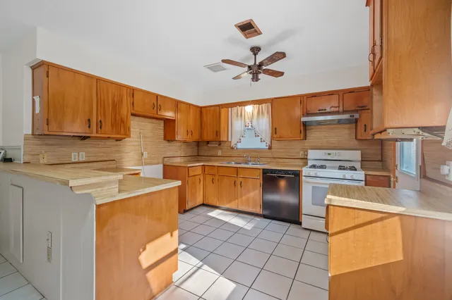 a kitchen with a stove a sink and a refrigerator