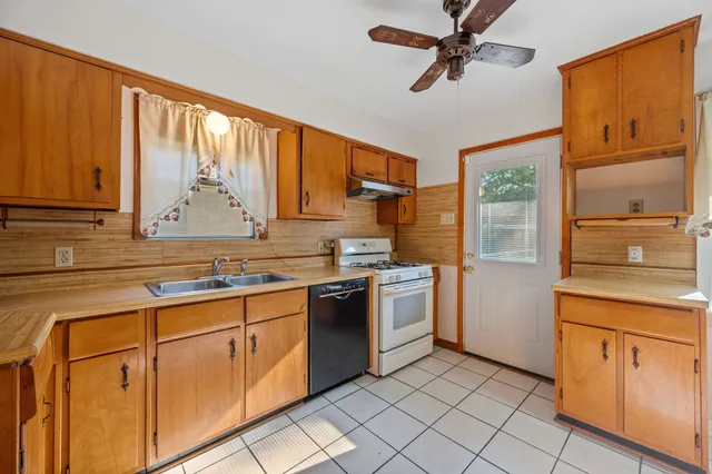 a kitchen with cabinets appliances and a window