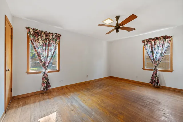 a view of room with window and wooden floor