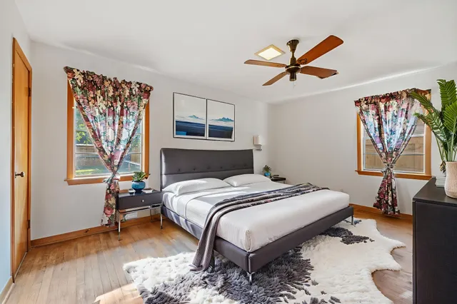 a bedroom with a bed and a chandelier