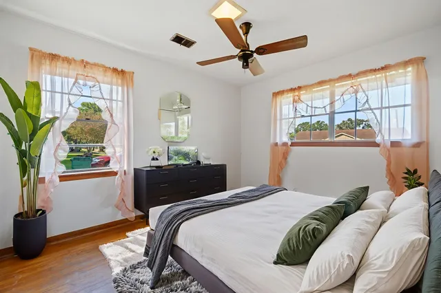 a bedroom with a large bed and a window