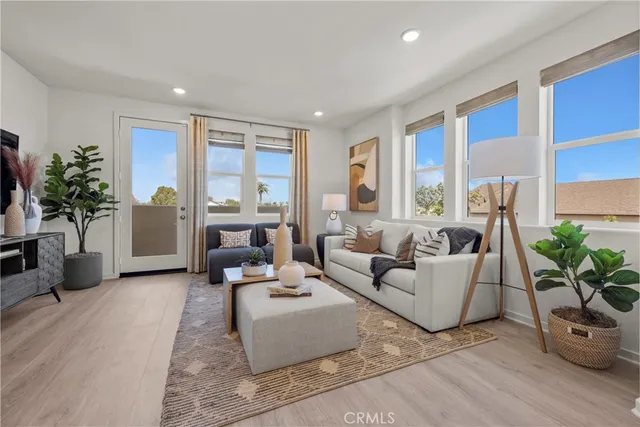 a living room with furniture and a potted plant