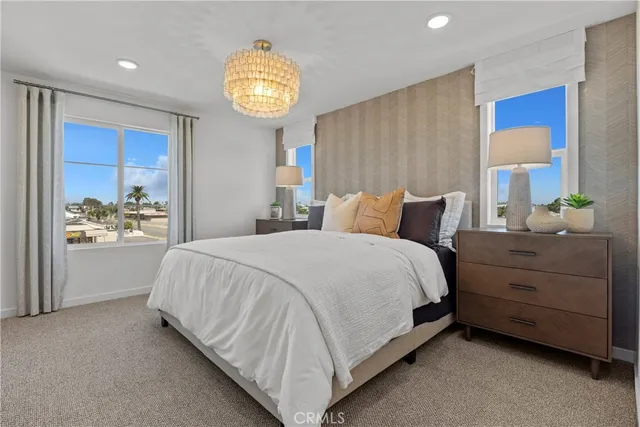 a bedroom with a bed and a chandelier
