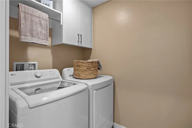 a view of storage and utility room with washer and dryer