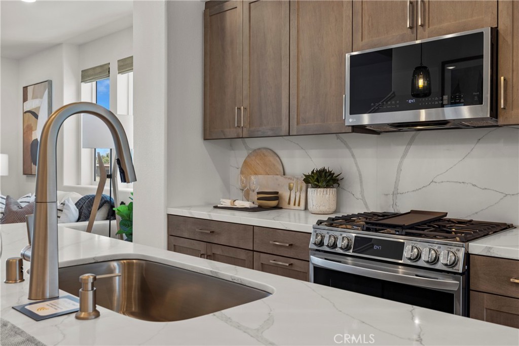 1950 West Sycamore Drive Compton, CA 90220 - Photo 19 of 23 a kitchen with a stove and a microwave