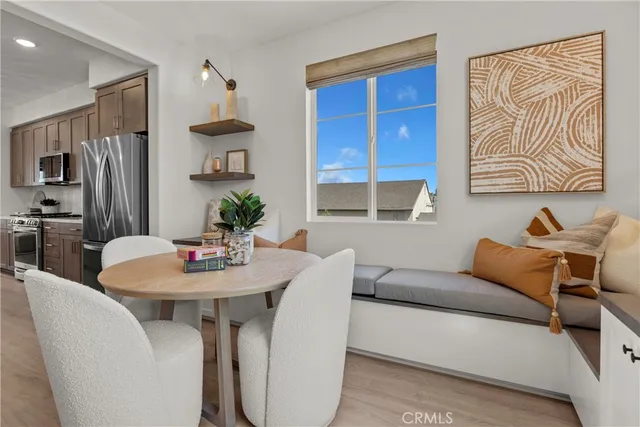a living room with furniture a refrigerator and a dining table