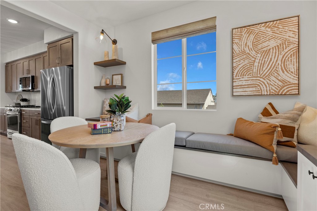 1950 West Sycamore Drive Compton, CA 90220 - Photo 21 of 23 a living room with furniture a refrigerator and a dining table