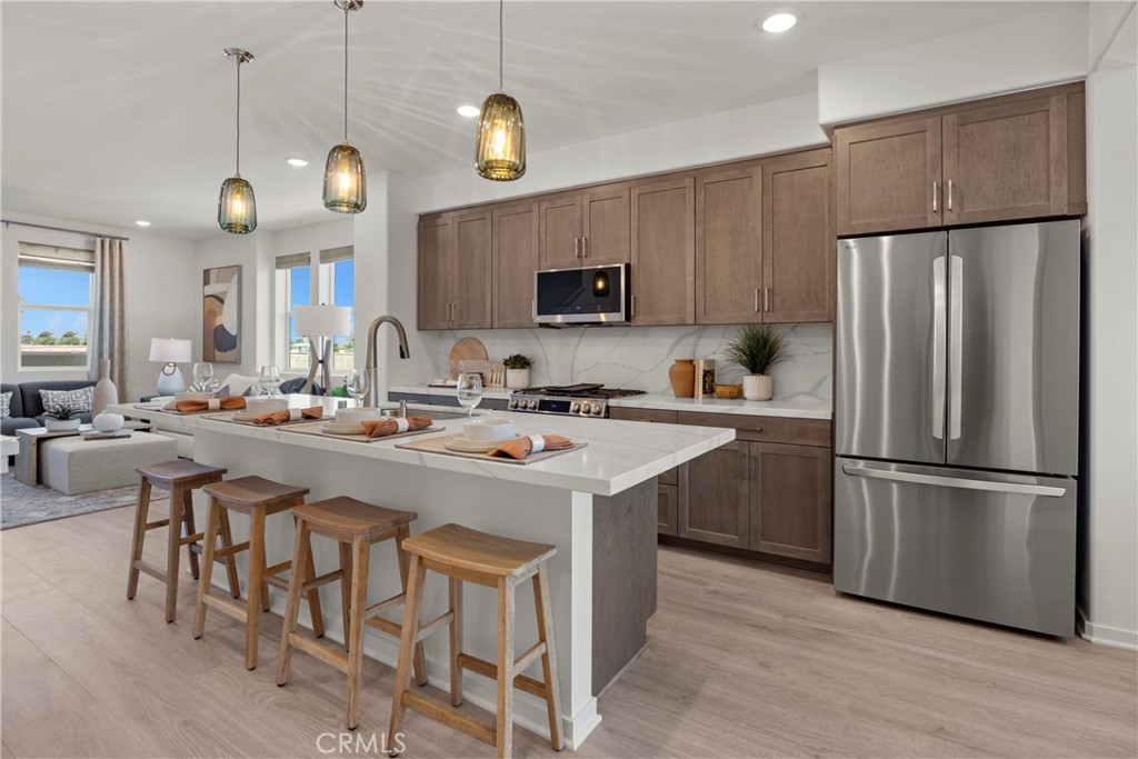 1950 West Sycamore Drive Compton, CA 90220 - Photo 9 of 23 a kitchen with stainless steel appliances granite countertop a sink a stove a refrigerator and a refrigerator with wooden floor