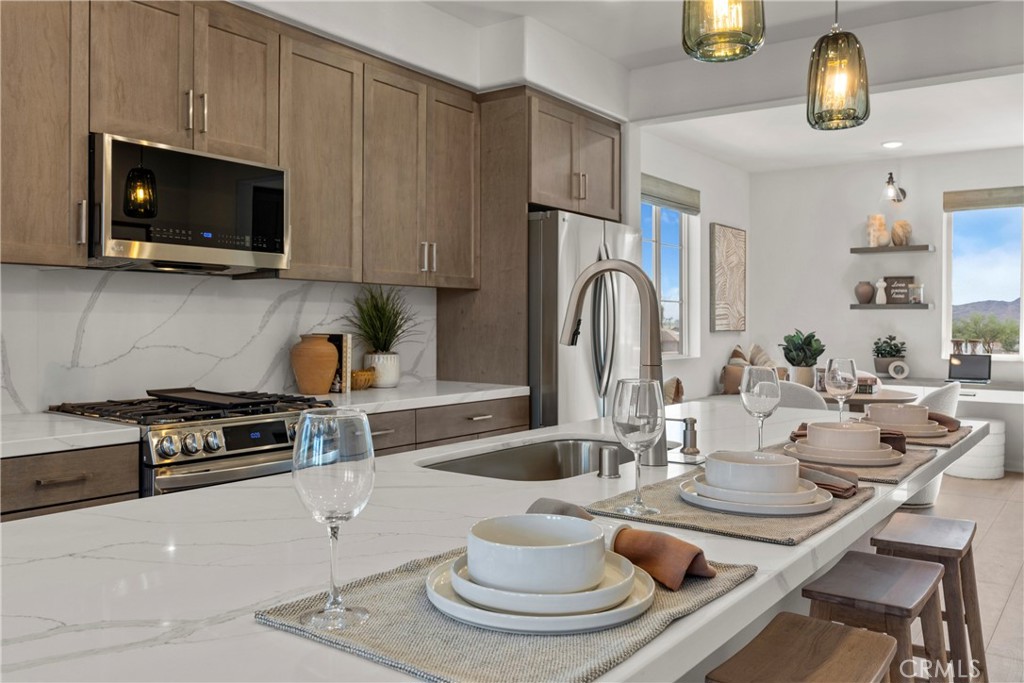 1950 West Sycamore Drive Compton, CA 90220 - Photo 10 of 23 a kitchen with a stove a microwave and dining table