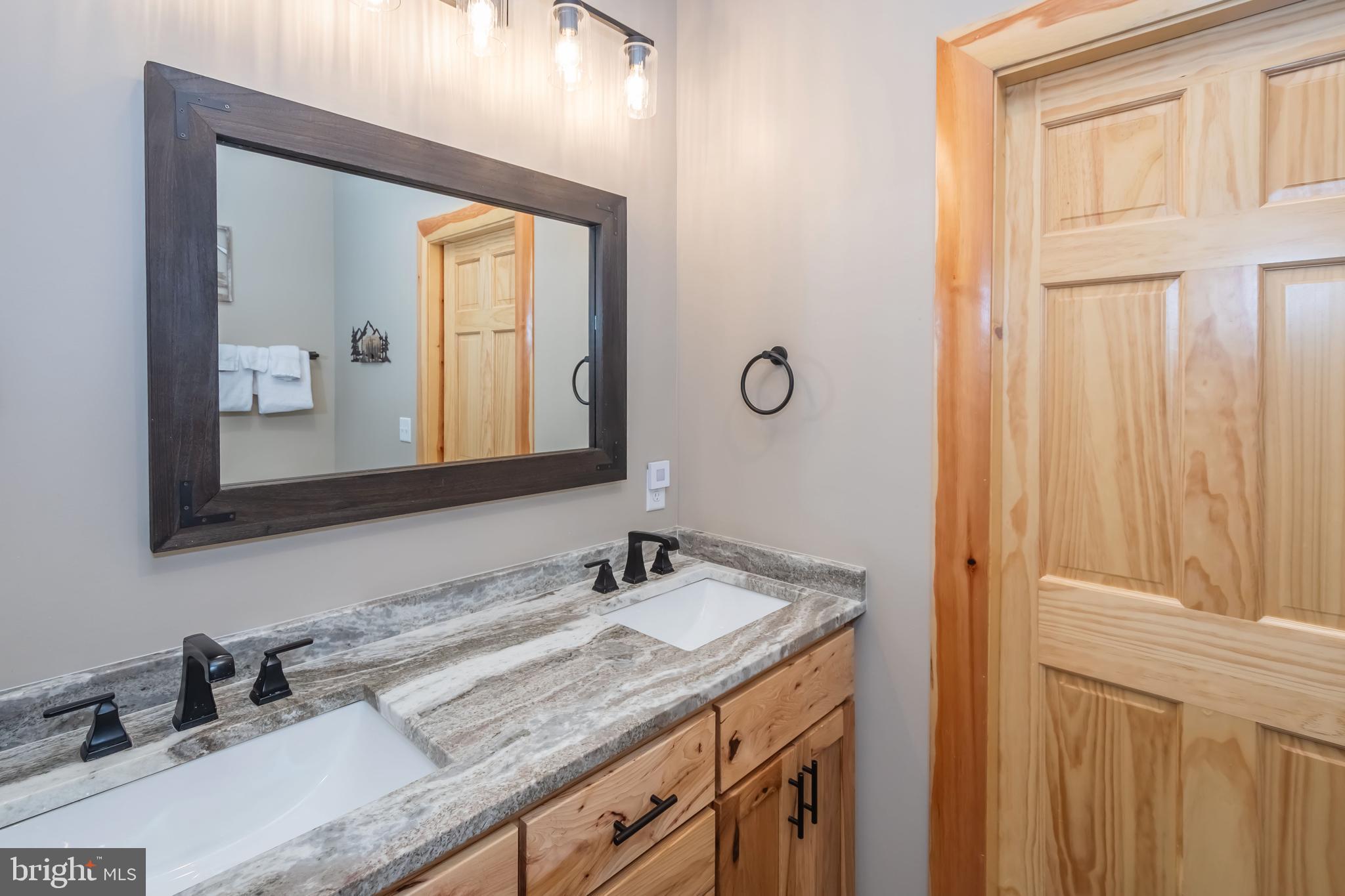 94 Sandy View Oakland, MD 21550 - Photo 25 of 64 a bathroom with 2 sink and a mirror