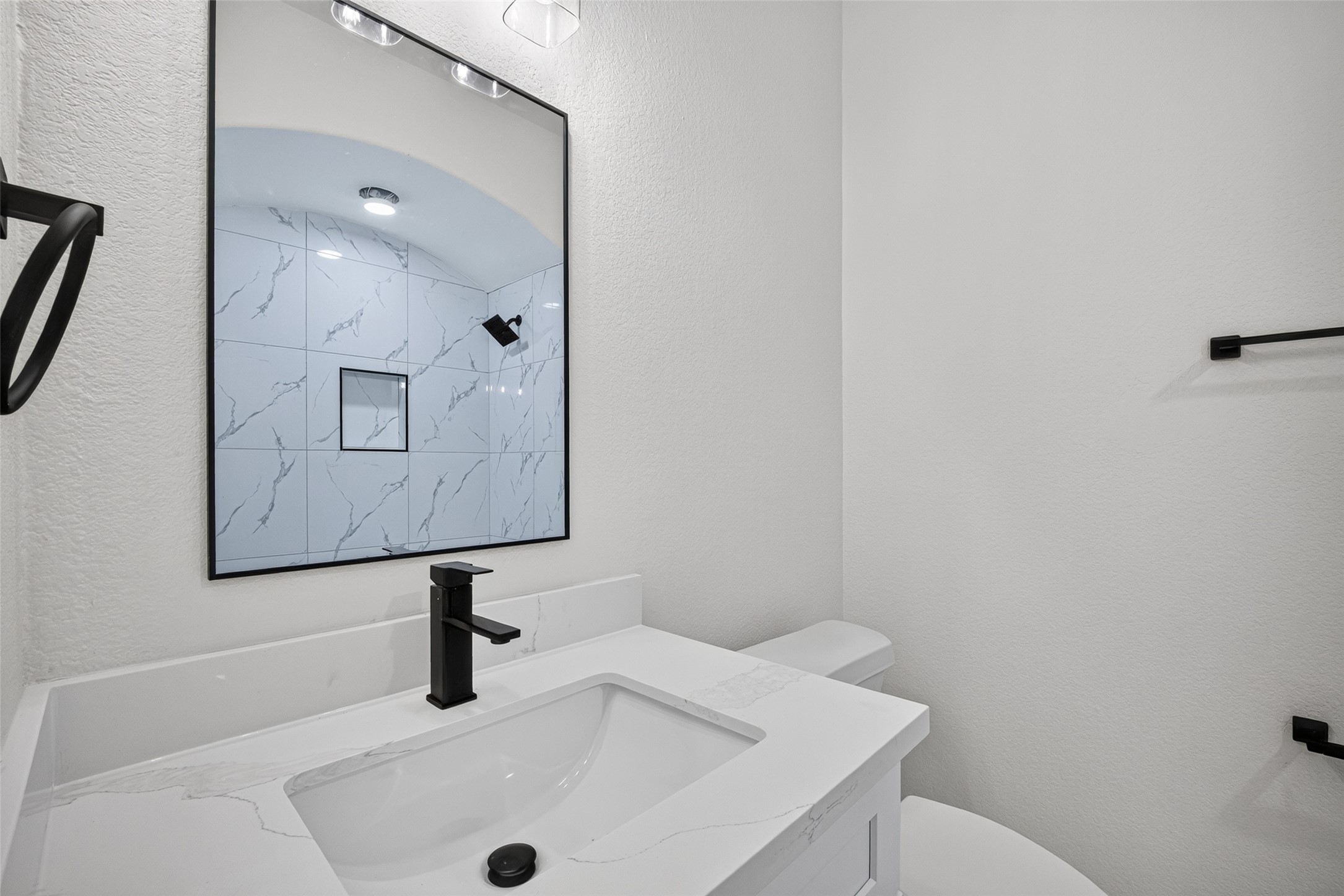 22623 Ebbets Field Drive Spring, TX 77389 - Photo 31 of 43 2nd Floor Full Bathroom: Step up to a modern vanity crowned with elegant marble, perfectly accented by crisp, stylish fixtures that elevate the whole room. Just beside it, the beautifully tiled shower space offers a clean, contemporary finish—making every morning routine feel instantly refreshed and luxurious.