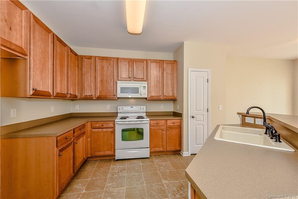 316 Sugar Ridge Court, Unit 95 Fort Mill, SC 29708 - Photo 11 of 23 a kitchen with stainless steel appliances granite countertop a sink stove and cabinets