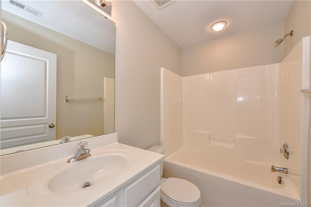 316 Sugar Ridge Court, Unit 95 Fort Mill, SC 29708 - Photo 19 of 23 a bathroom with a bathtub shower sink vanity mirror and toilet