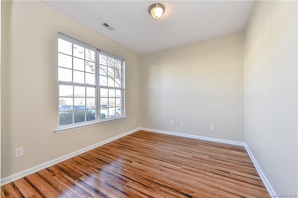 316 Sugar Ridge Court, Unit 95 Fort Mill, SC 29708 - Photo 3 of 23 an empty room with wooden floor and windows