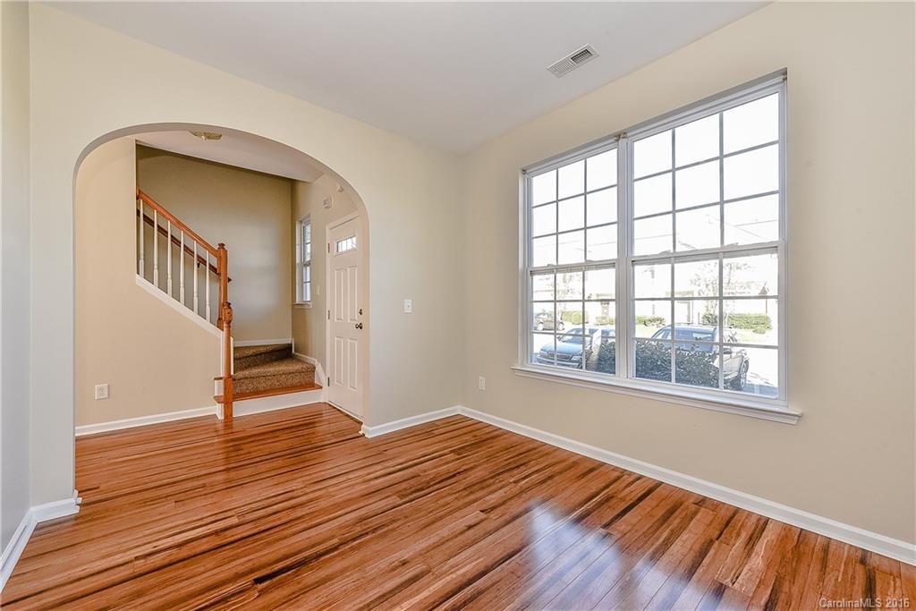 316 Sugar Ridge Court, Unit 95 Fort Mill, SC 29708 - Photo 4 of 23 a view of an empty room with wooden floor and a window