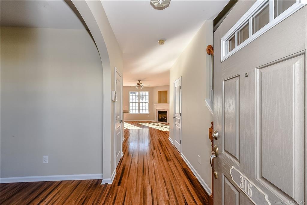 316 Sugar Ridge Court, Unit 95 Fort Mill, SC 29708 - Photo 5 of 23 a view of a hallway with wooden floor and staircase