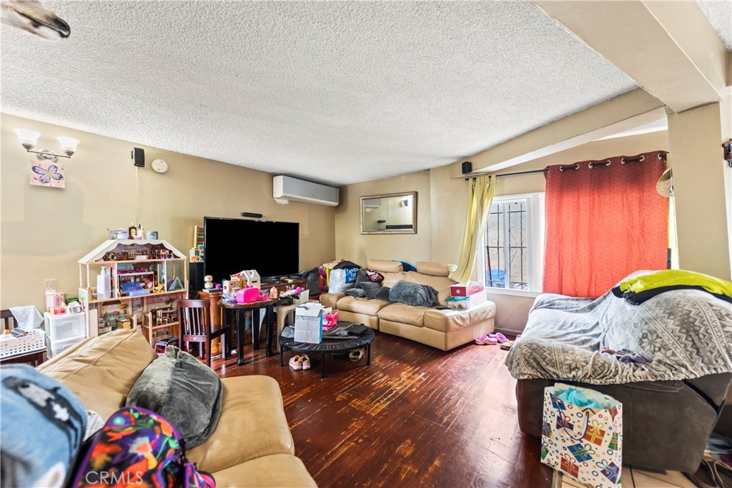 2424 West Boulevard Los Angeles, CA 90016 - Photo 11 of 21 a living room with furniture and a flat screen tv