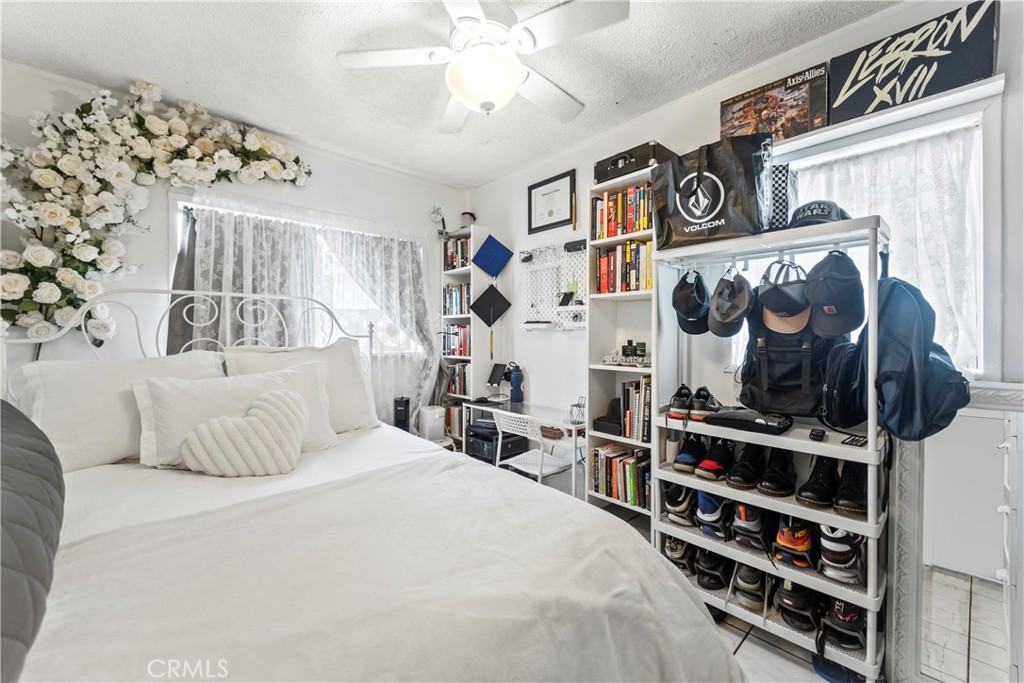 2424 West Boulevard Los Angeles, CA 90016 - Photo 7 of 21 a bedroom with a bed and a book shelf