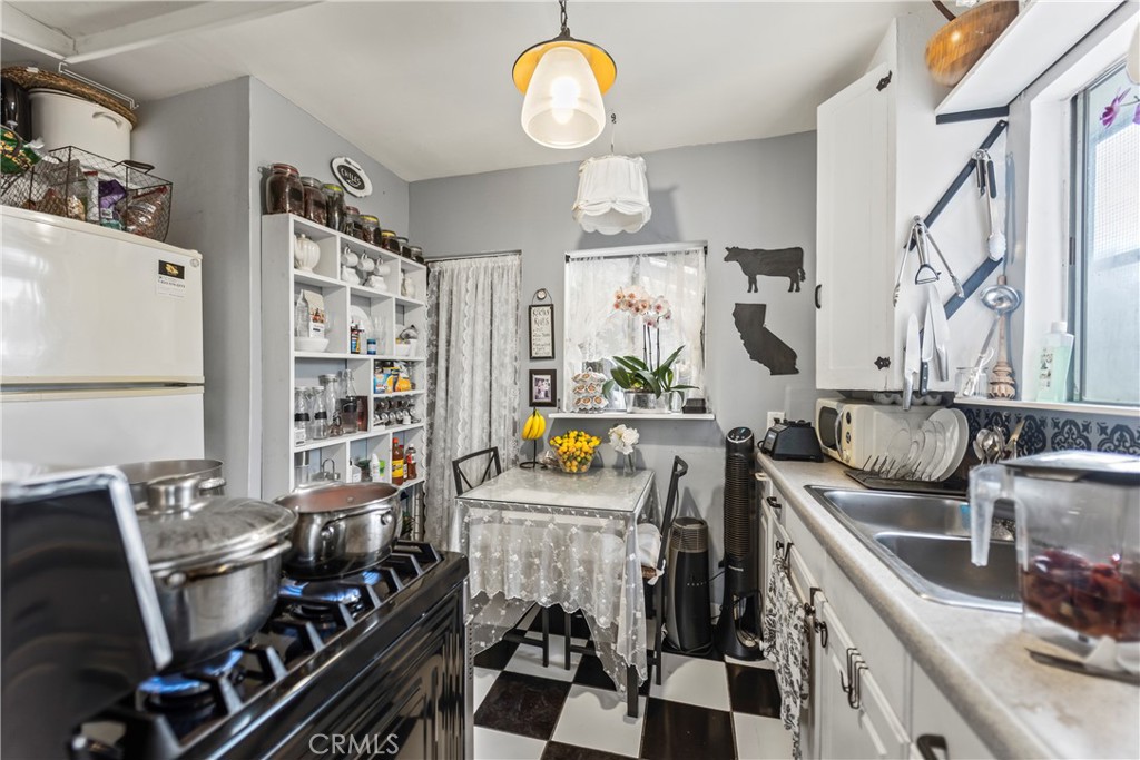 2424 West Boulevard Los Angeles, CA 90016 - Photo 10 of 21 a view of a kitchen with stainless steel appliances granite countertop a sink stove and a refrigerator