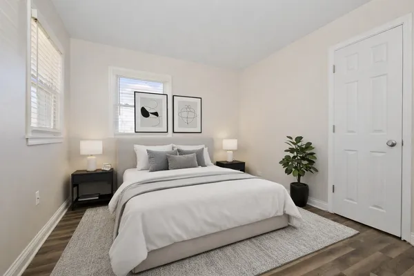 a bedroom with a bed and a potted plant