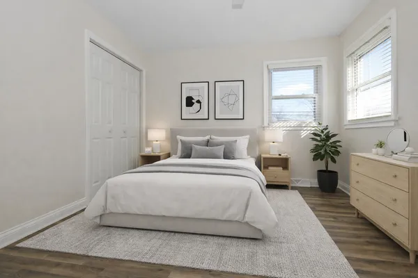a bedroom with a bed and a potted plant