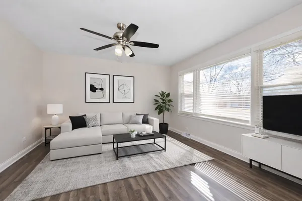 a living room with furniture a window and a flat screen tv