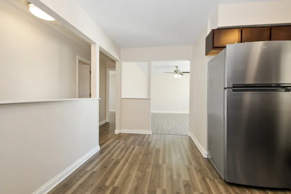 a view of walk in closet with wooden floor