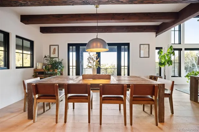 a dining room with furniture a chandelier and wooden floor
