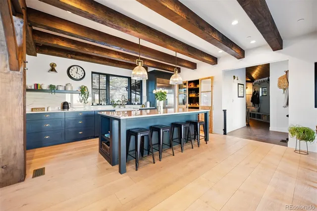 a dining hall with stainless steel appliances granite countertop a stove and cabinets