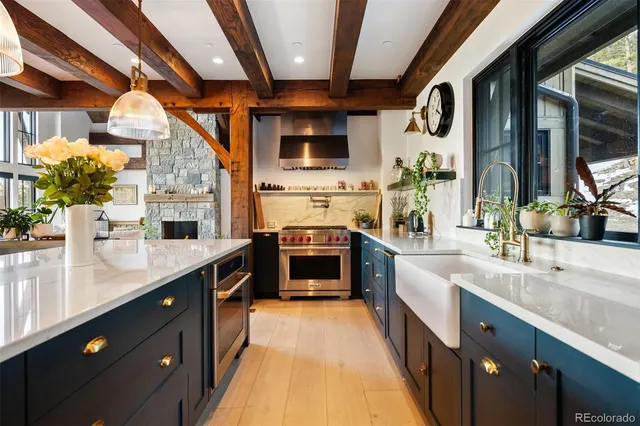 a large kitchen with stainless steel appliances granite countertop a large stove and a sink