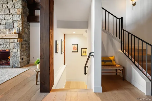 a view of a hallway with wooden floor and staircase