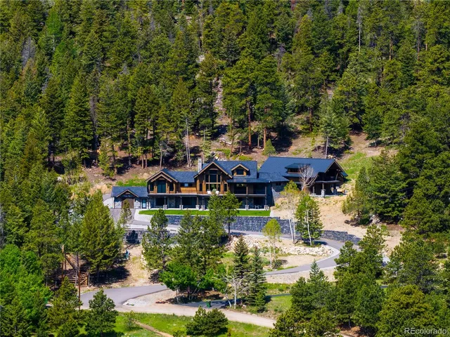 an aerial view of a house with yard swimming pool and outdoor seating
