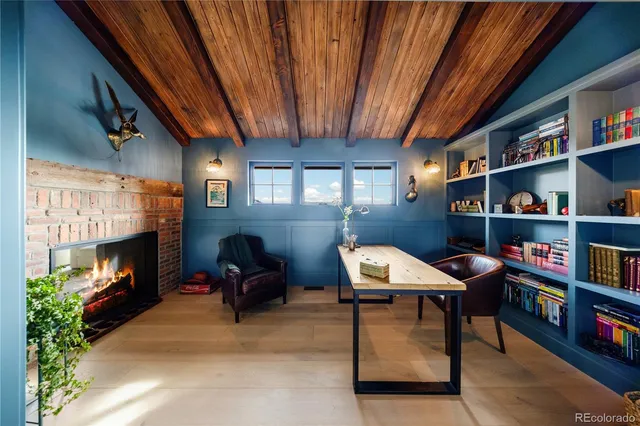 a workspace with furniture bookshelf and a fireplace