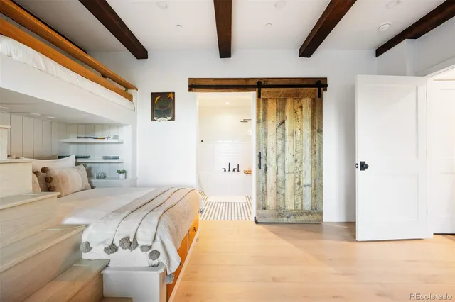 a bedroom with a bed and a mirror