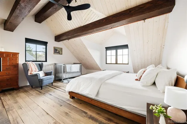 a bedroom with bed couch and window