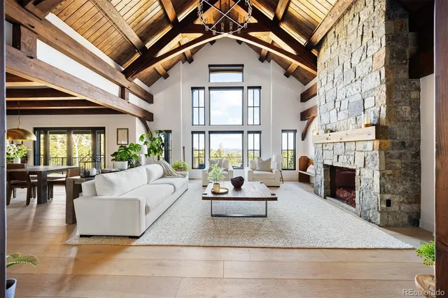a living room with furniture a fireplace and a large window