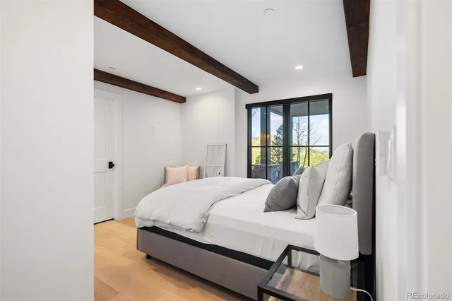 a bedroom with a bed and glass window