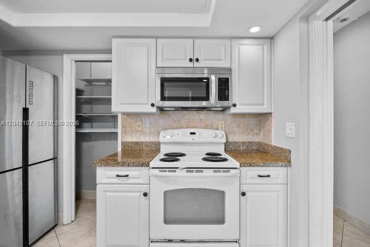 3213 Colony Club Road, Unit 3E Pompano Beach, FL 33062 - Photo 14 of 31 a kitchen with stainless steel appliances white cabinets and a stove
