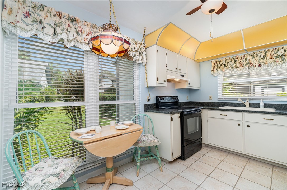 10615 Roxbury Court Lehigh Acres, FL 33936 - Photo 11 of 33 a kitchen with a sink and a stove