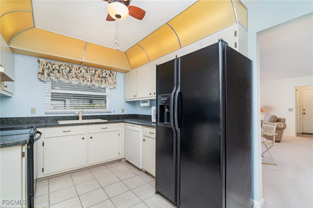 10615 Roxbury Court Lehigh Acres, FL 33936 - Photo 12 of 33 a kitchen with stainless steel appliances granite countertop a refrigerator and a sink