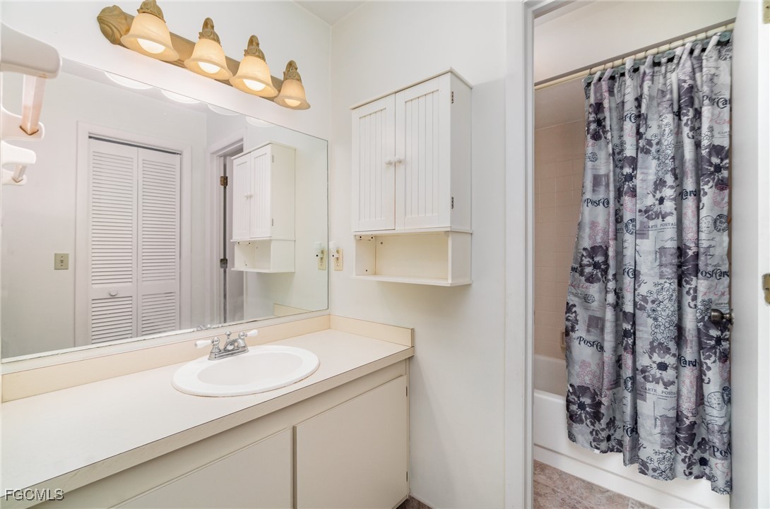 10615 Roxbury Court Lehigh Acres, FL 33936 - Photo 17 of 33 a bathroom with a sink double vanity and a mirror