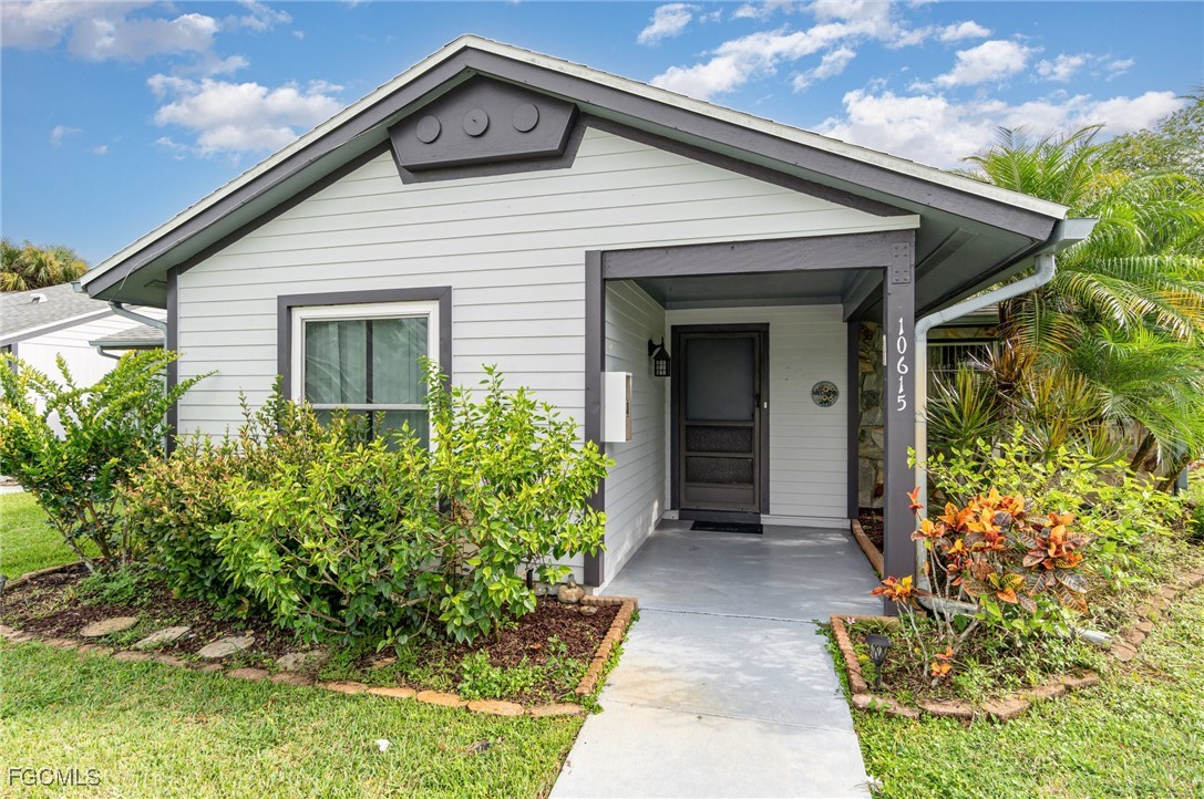 10615 Roxbury Court Lehigh Acres, FL 33936 - Photo 2 of 33 a view of a house with potted plants
