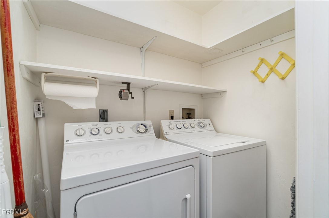 10615 Roxbury Court Lehigh Acres, FL 33936 - Photo 21 of 33 a utility room with dryer and washer
