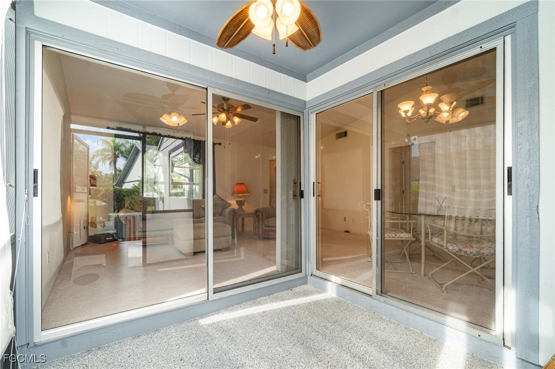 10615 Roxbury Court Lehigh Acres, FL 33936 - Photo 22 of 33 a view of a hallway with wooden floor and a glass door shower