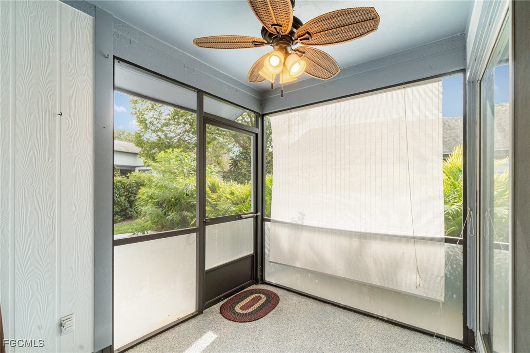 10615 Roxbury Court Lehigh Acres, FL 33936 - Photo 23 of 33 a view of an empty room and window with a chandelier fan